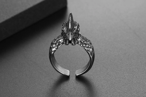 Macro detail of retro rooster ring featuring antique finish and intricate feather textures