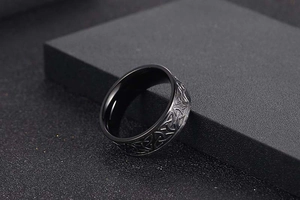 Macro view of black Viking steel ring with detailed Celtic knot patterns and matte finish