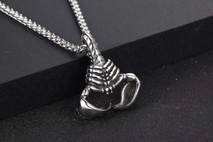Macro shot of detailed vintage titanium steel scorpion pendant with a gothic rock style