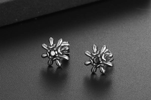 Macro view of vintage sunflower earrings with black faceted zircon in titanium steel