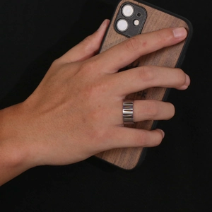 Men's titanium steel ring with textured colorful ripple design in a minimalist industrial style