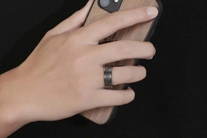 Close-up of vintage silver Viking ring with Celtic knot relief on man's hand