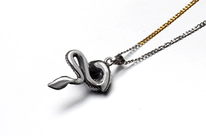 Detailed close-up of retro titanium steel dragon pendant with intricate silver scales