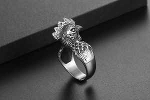 Macro shot of vintage silver rooster ring detailing exquisite feathers and crest texture