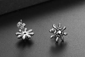 Macro view of sunflower stud earrings with black zircon inlay and silver steel finish