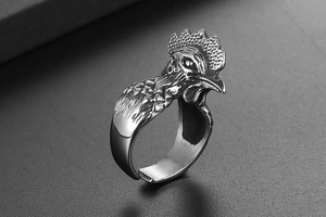 Detailed macro view of retro rooster head ring with antique finish and open band