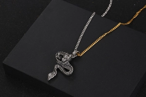 Detailed view of silver dragon pendant necklace with intricate scale texture on black stand