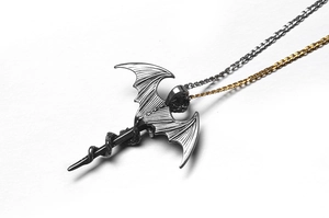 Detailed macro view of Gothic dragon sword pendant with intricate snake wrap relief