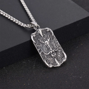 Vintage titanium steel necklace featuring embossed dragon pendant on a black pedestal