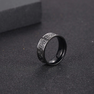 Men's black titanium steel Viking ring with etched Celtic knot patterns and polished interior