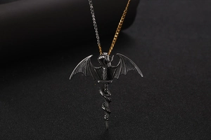 Macro detail of gothic dragon wrapped around a sword pendant with dual-tone metal chain