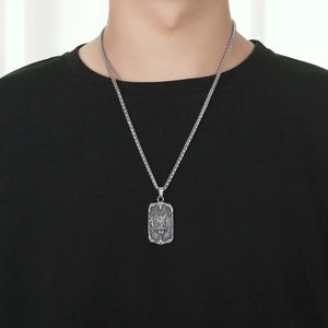 Men's retro titanium steel dragon pendant necklace with silver woven chain on black shirt