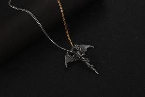Detail of dragon sword pendant with gold and silver curb chain in vintage titanium steel