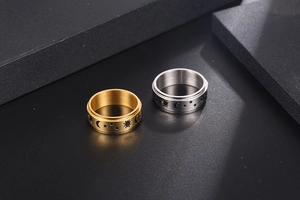Detail of gold and silver titanium rings with sun, moon, and star astrological engravings
