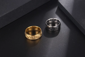 Close-up of gold and silver steel rings featuring intricate vintage Celtic knot engravings