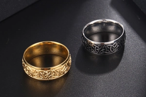 Macro detail of Nordic Viking rings in gold and silver steel with Celtic knot engravings
