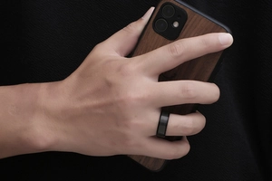 Close-up of black titanium ring with snakeskin grid texture on a male finger
