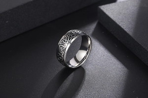 Detailed close-up of a Viking steel ring featuring intricate Celtic knot engravings