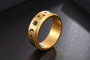 Macro shot of gold titanium steel ring featuring engraved sun moon and star patterns