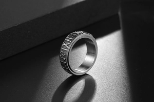 Macro shot of Nordic Runes engraved on a retro stainless steel men's ring