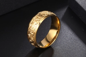 Macro view of gold Viking Celtic Knot engraving on a polished stainless steel ring