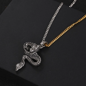 Retro dragon pendant necklace featuring a bicolor silver and gold Cuban link chain