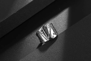Macro detail of vintage stainless steel ring with embossed poker card patterns