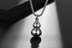 Detailed close-up of a silver-tone stainless steel hulu pendant on a square box chain