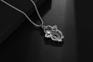 Detail shot of vintage titanium steel bear pendant with intricate woven chain