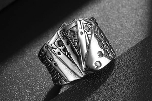 Macro shot of vintage titanium steel ring featuring embossed spade poker cards detail