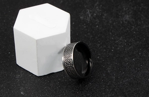 Detail shot of men's vintage Celtic knot ring with black matte inner coating and silver finish