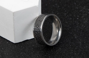 Macro detail of Nordic vintage Celtic knot pattern on stainless steel ring surface