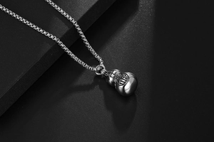 Macro shot of silver hulu gourd pendant with Fu character on polished steel chain
