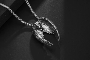Gros plan du pendentif ailes d'ange en acier titane avec texture de plumes détaillée