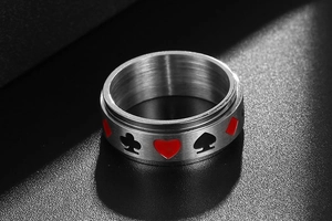 Vue rapprochée d'une bague rotative en titane avec motifs de poker sur métal brossé mat