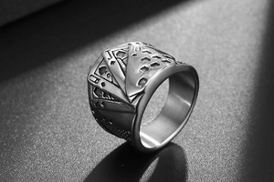 Detailed relief of poker cards J and 10 on a wide stainless steel band for men