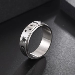 Rotating stainless steel anxiety ring featuring sun moon and stars celestial engravings
