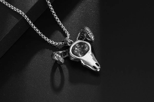 Macro shot of punk style stainless steel bull skull pendant with fine carving details