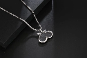 Macro shot of silver titanium necklace showing hammered metal texture on heart pendant