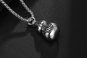 Macro shot of silver titanium steel gourd pendant with engraved Fu character detail