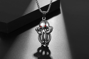 Macro shot of vintage titanium steel octopus pendant with red rhinestone eyes and textures
