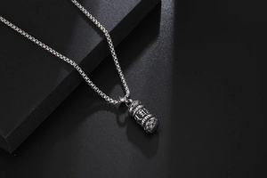 Detail of vintage lotus mantra pendant in titanium steel with classic box chain