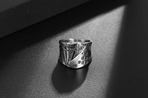 Macro detail of royal flush poker card engraving on a vintage steel ring band