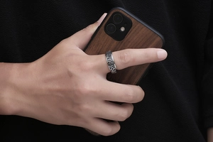 Detail of vintage men's stainless steel ring with Nordic Runes engraving on finger