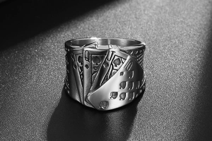 Macro shot of titanium steel ring with poker royal flush relief and vintage finish