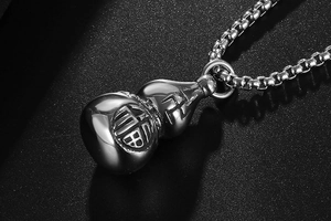 Macro shot of stainless steel gourd pendant with engraved Fu character and F卍 symbol