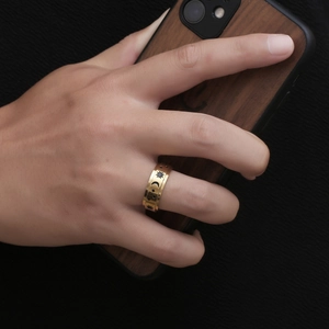 Gold stainless steel ring featuring celestial sun and moon engravings on hand
