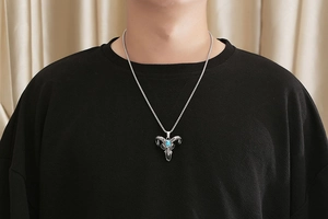 Gothic bull skull necklace with blue turquoise inlay worn on a black casual t-shirt