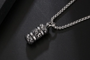 Macro detail of Scorpio zodiac pendant with vintage engraving on a steel chain