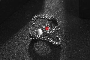 Close-up of vintage octopus ring with red crystal and textured stainless steel suckers